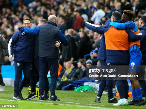Wigan Athletic manager Paul Cook and his staff celebrate after his side scored during the Sky Bet Championship match between Leeds United and Wigan...