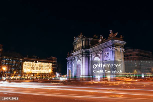 puerta de alcalá of the city of madrid spain at christmas night. - madrid landmark stock pictures, royalty-free photos & images