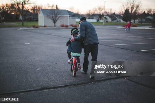 man assisting a young boy ride a bike - pedal ストックフォトと画像