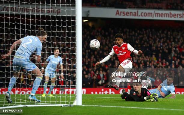 Reiss Nelson of Arsenal scores his side's first goal during the FA Cup Third Round match between Arsenal FC and Leeds United at the Emirates Stadium...