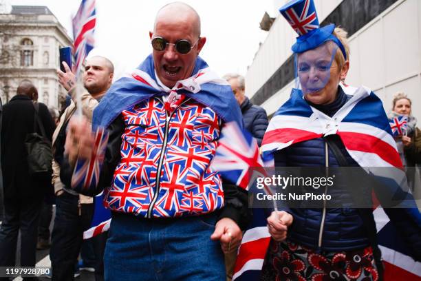 Brexit supporters in Union Jack colours celebrate on Parliament Street in London, England, on January 31, 2020. Britain's exit from the European...