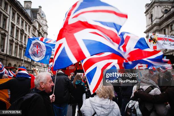 Brexit supporters wave Union Jack flags amid celebrations on Parliament Street in London, England, on January 31, 2020. Britain's exit from the...