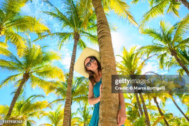 beautiful playful woman among palm trees, yucatan peninsula, mexico - cultura caraibica foto e immagini stock