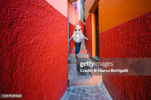 Tourist exploring a narrow alley in Guanajuato, Mexico