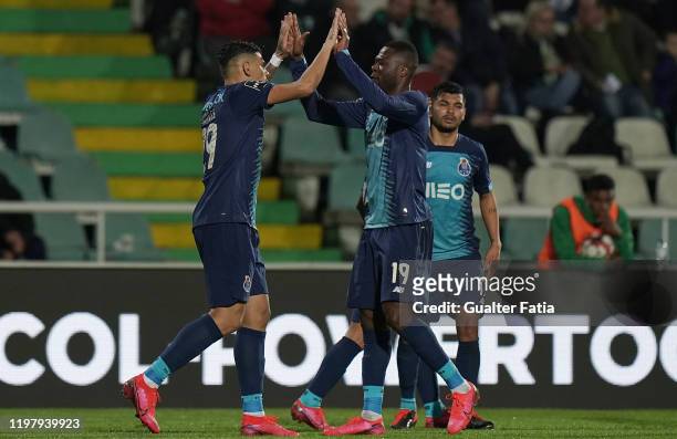 Tiquinho Soares of FC Porto celebrates with teammate Chancel Mbemba of FC Porto after scoring the third goal of their team during the Liga NOS match...