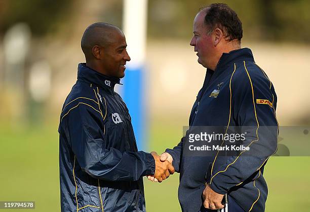 Consultant coach George Gregan and head Coach Jake White shake hands during an ACT Brumbies training camp at Narrabeen Sport and Recreation Ground on...