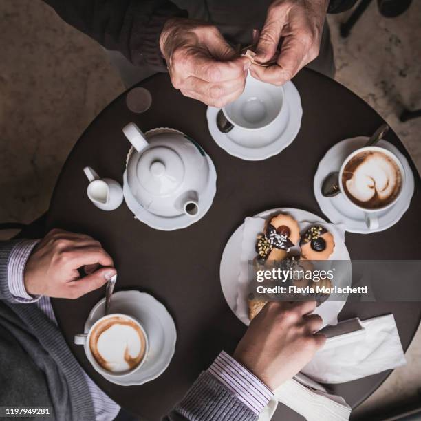 having breakfast at the cafeteria - sharing coffee stockfoto's en -beelden