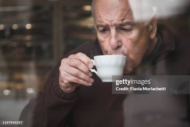 senior man drinking tea - senior men cafe stock pictures, royalty-free photos & images