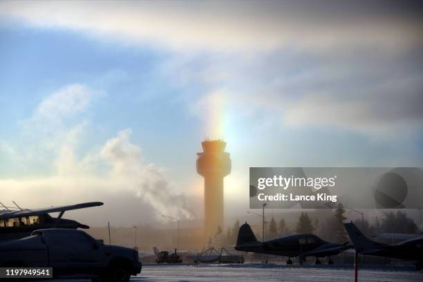 An ice rainbow appears through ice fog at Ted Stevens Anchorage International Airport on January 6, 2020 in Anchorage, Alaska. These rare rainbows...