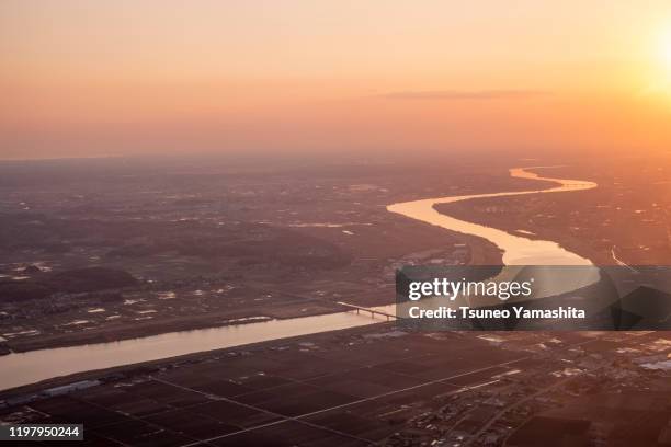 sunset of tone river seen from an airplane - narita international airport stock-fotos und bilder