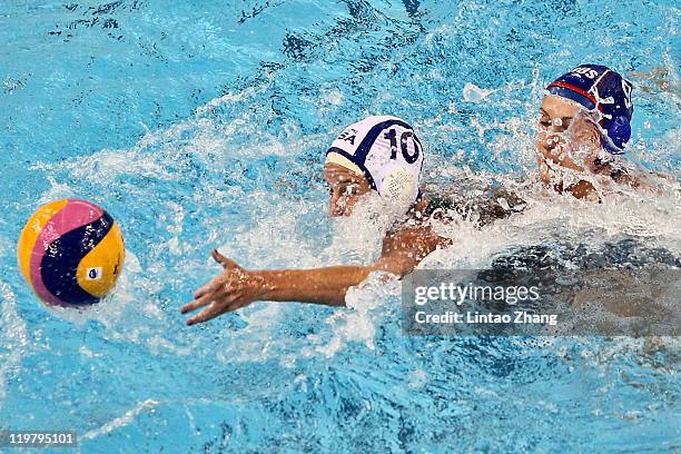 Kristen Rulon Kelly of United States challenges Ekaterina Tankeeva of Russia in the Women's Water Polo first preliminary round match between Russia...