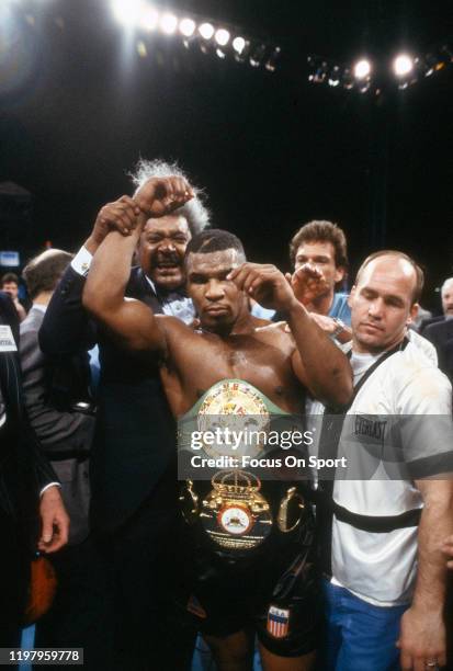 Mike Tyson celebrates wearing both belts after he defeated James Smith for the WBA and WBC Heavyweight tittles on March 7, 1987 at the Las Vegas...