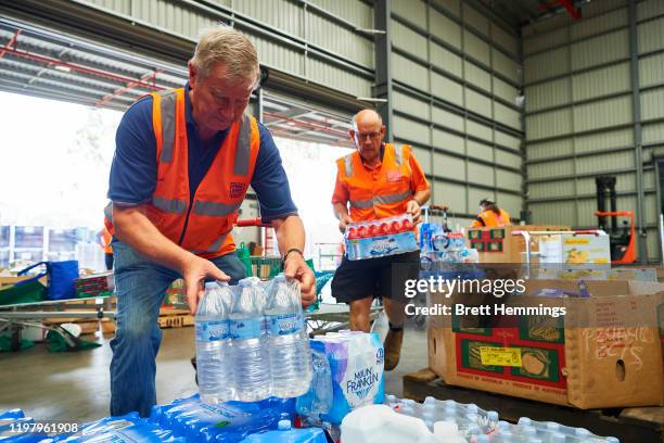 Volunteers help help organise large donations of goods at the Food Bank Distribution Centre bound for areas impacted by bushfires on January 07, 2020...