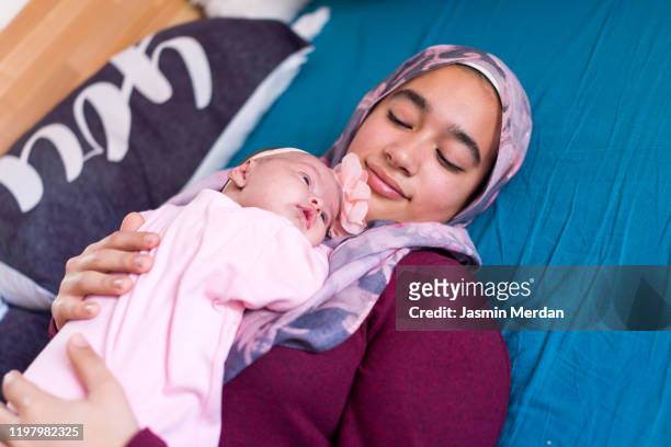 young asian mother with baby - pregnant muslim stock pictures, royalty-free photos & images