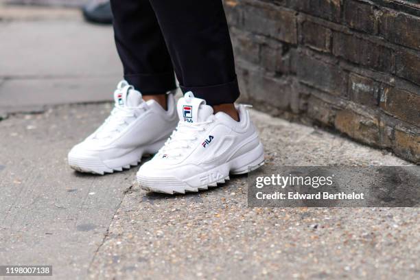 Fila white sneakers are seen, during London Fashion Week Men's June 2019 on June 08, 2019 in London, England.