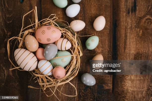 easter eggs on wooden background - easter egg stock pictures, royalty-free photos & images