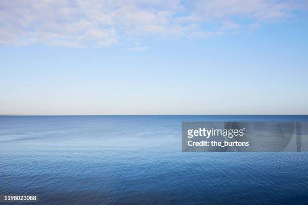 full frame shot of sea, clouds and clear sky, abstract blue background - horizont stock-fotos und bilder