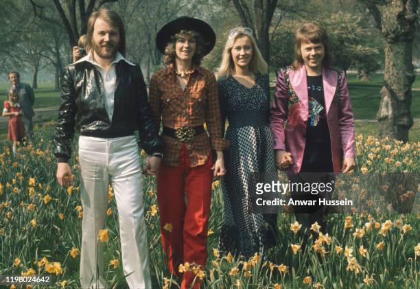 Swedish pop group Abba, winners of the 1974 Eurovision Song Contest at Brighton, strolling hand in hand amongst the daffodils in Hyde Park on April...