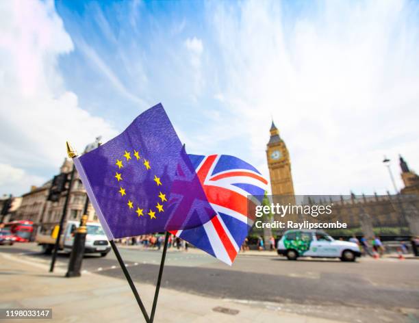 european flag flying alongside the british union jack in front of the houses of parliament, westminster, london. highlighting the departure from the european union. plenty of text space. - article 50 of the treaty on european union stock pictures, royalty-free photos & images