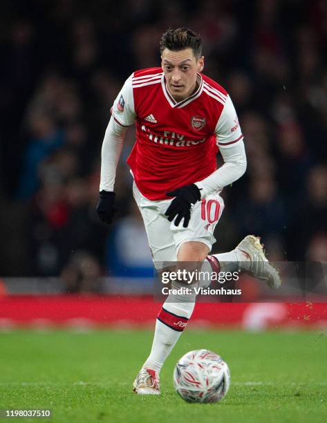 Mesut Ozil of Arsenal and Kalvin Phillips of Leeds United during the FA Cup Third Round match between Arsenal FC and Leeds United at the Emirates...