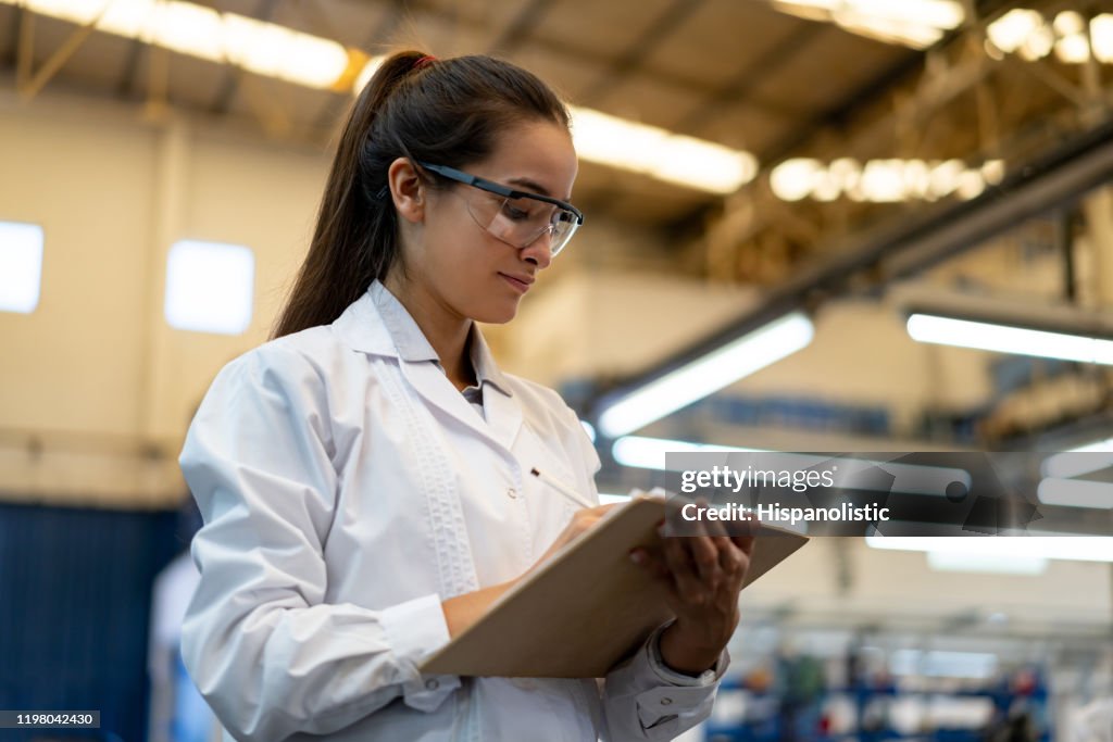 Woman Quality Control Young Female Quality Control Inspector At A Factory Holding A Clipboard ...