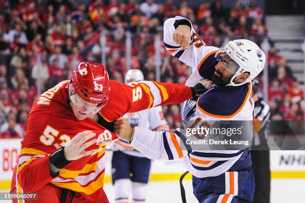 Buddy Robinson of the Calgary Flames fights Jujhar Khaira of the Edmonton Oilers during an NHL game at Scotiabank Saddledome on February 1, 2020 in...