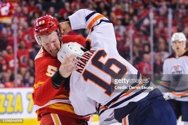 Buddy Robinson of the Calgary Flames fights Jujhar Khaira of the Edmonton Oilers during an NHL game at Scotiabank Saddledome on February 1, 2020 in...