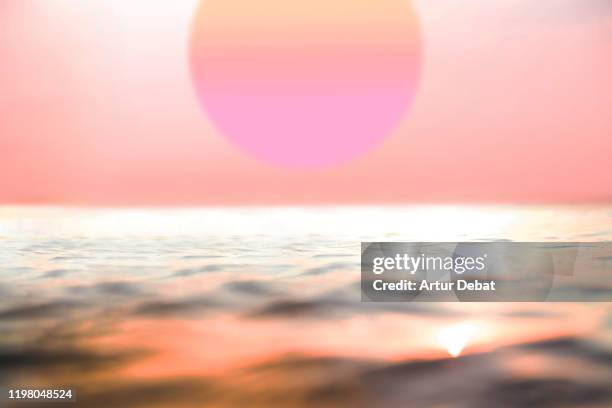 huge sun during beautiful pink sunset with the sea in bali. - bokeh love stock pictures, royalty-free photos & images
