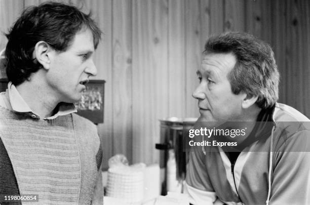 English soccer player Mick Channon of Norwich City FC talks to his manager Ken Brown, UK, 21st March 1985.