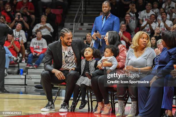 All-star and San Diego State Aztecs alumni Kawhi Leonard celebrates with his family at halftime of a college basketball game between the Utah State...