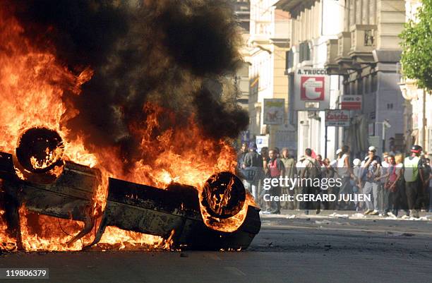 Car burns after anti-globalisation activists clashed with the police during a protest against the G8 summit in Genoa 21July 2001. Italian police and...