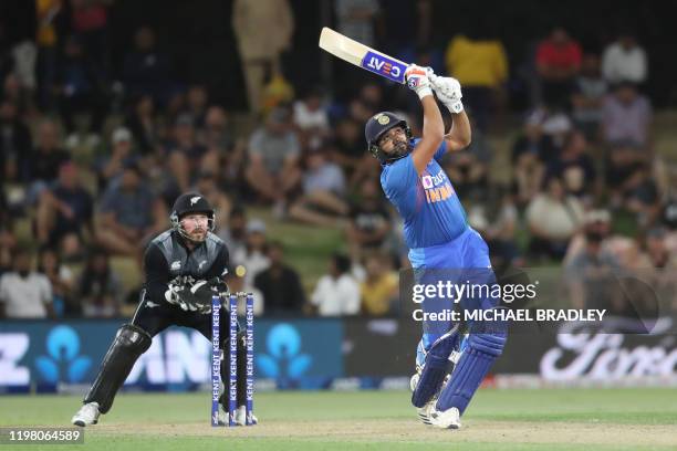 Indias Rohit Sharma bats watched by New Zealands Tim Seifert during the fifth Twenty20 cricket match between New Zealand and India at the Bay Oval in...