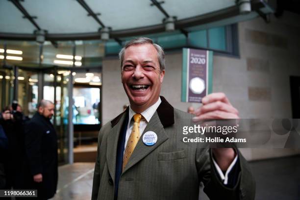 Brexit Party leader and former MEP, Nigel Farage holds up commemorative 50p coin as he arrives to appear on the Andrew Marr Show at BBC Television...