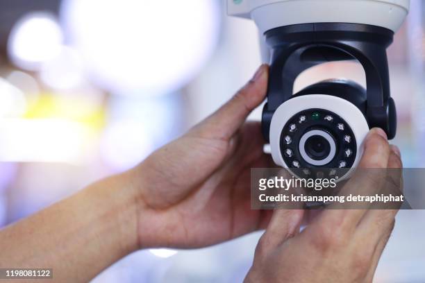 technician installing cctv camera by screwed for home security system - security camera stock pictures, royalty-free photos & images