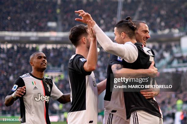 Juventus' Portuguese forward Cristiano Ronaldo celebrates with Juventus' Italian defender Leonardo Bonucci , Juventus' Bosnian midfielder Miralem...