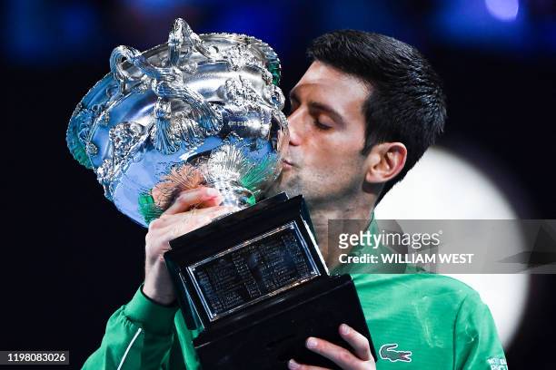 Serbia's Novak Djokovic kisses the Norman Brooks Challenge Cup trophy following his victory against Austria's Dominic Thiem in their men's singles...