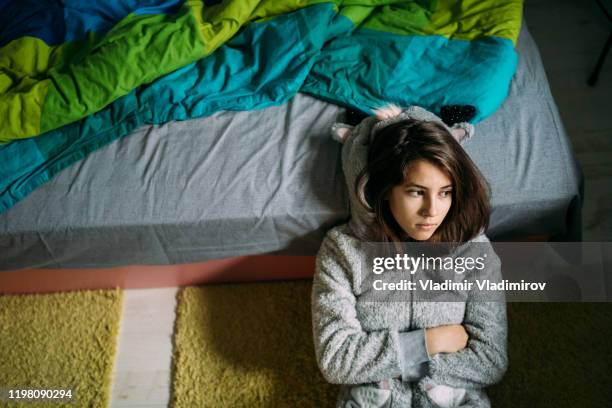 depressed young girl sitting on the floor - addiction recovery stock pictures, royalty-free photos & images