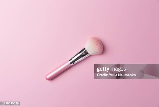 pink professional makeup brush for powder and eye shadows, isolated on pink background. - make up brush stockfoto's en -beelden