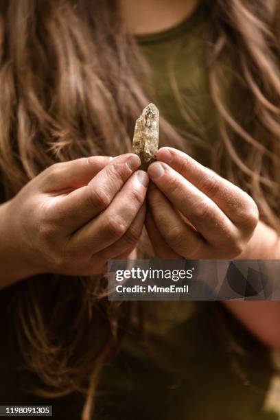 alternative medecine, young woman giving a crystal healing treatement - healing crystals stock pictures, royalty-free photos & images