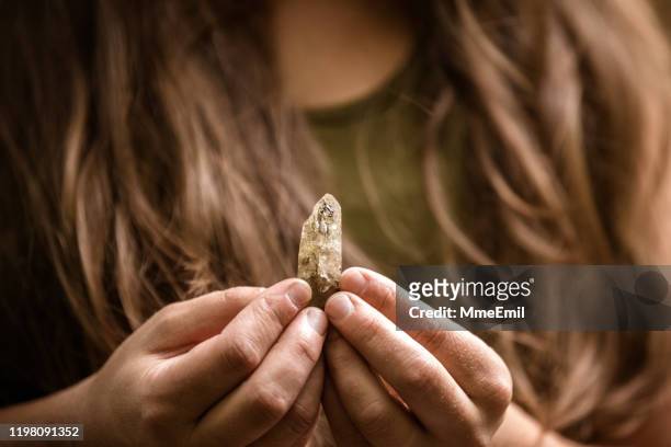 alternative medecine, young woman giving a crystal healing treatement - healing crystals stock pictures, royalty-free photos & images