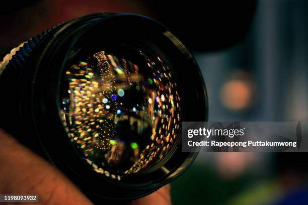 front of the lens of photographer being taking pictures decorative lights - camera lens flare stock pictures, royalty-free photos & images