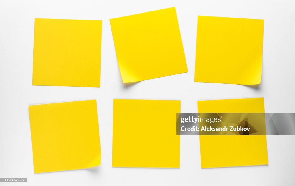 Yellow Sticky Stickers On A White Background To Remind You Of Information. Space For Text.