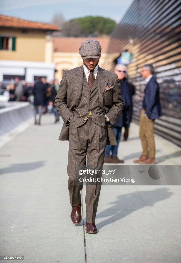 A guest is seen wearing brown flat cap, suit during Pitti Uomo 97 at ...