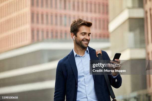 smiling handsome male entrepreneur surfing net - barba incolta foto e immagini stock