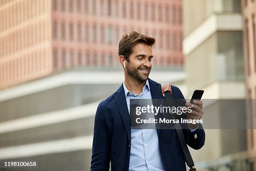 Smiling handsome male entrepreneur surfing net Smiling handsome male entrepreneur surfing net