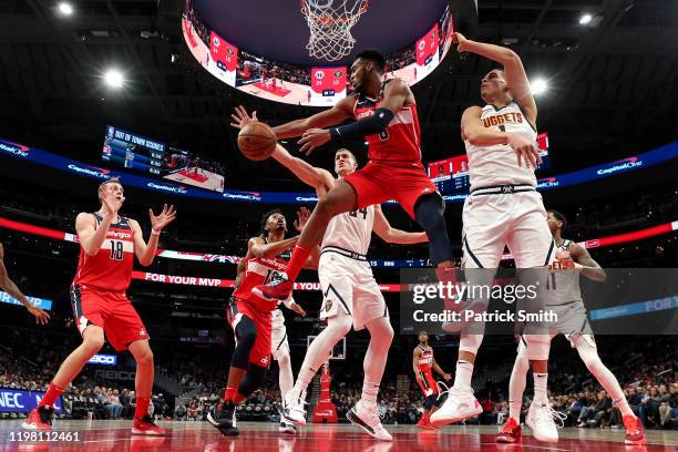Troy Brown Jr. #6 of the Washington Wizards looks to pass the ball in front of Michael Porter Jr. #1 of the Denver Nuggets during the first half at...