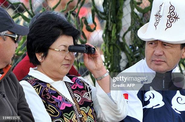 Kyrgyz President Roza Otunbayeva watches with binoculars the traditional folk festival in Son-Kul lake -- 3016 metres above the sea level --, 430...