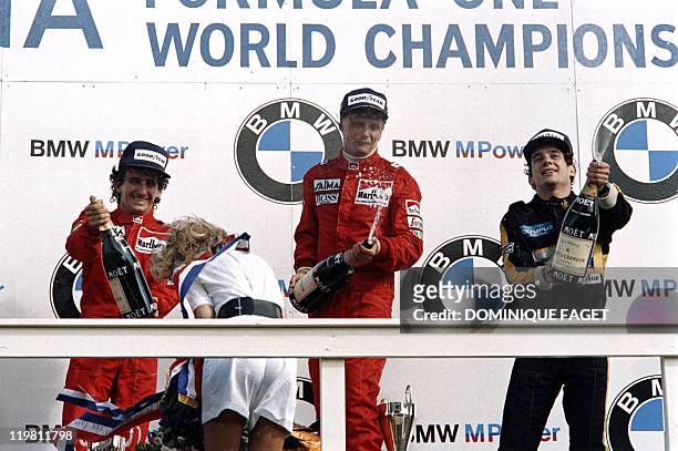 World champion Niki Lauda of Austria celebrates his victory on the podium after winning the Dutch Formula One Grand Prix on August 25, 1985 in...