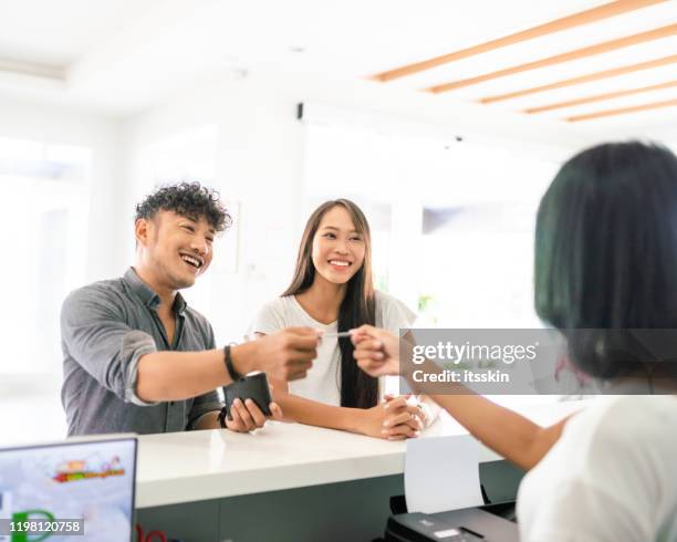 customers paying the bill at the hospital counter - paying doctor stock pictures, royalty-free photos & images