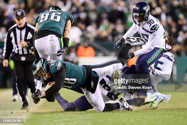 Josh McCown of the Philadelphia Eagles dives forward for extra yards on a run against the Seattle Seahawks in the NFC Wild Card Playoff game at...